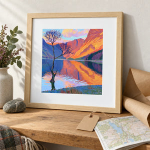 A framed Buttermere print unwrapped from kraft paper beside an OS map
