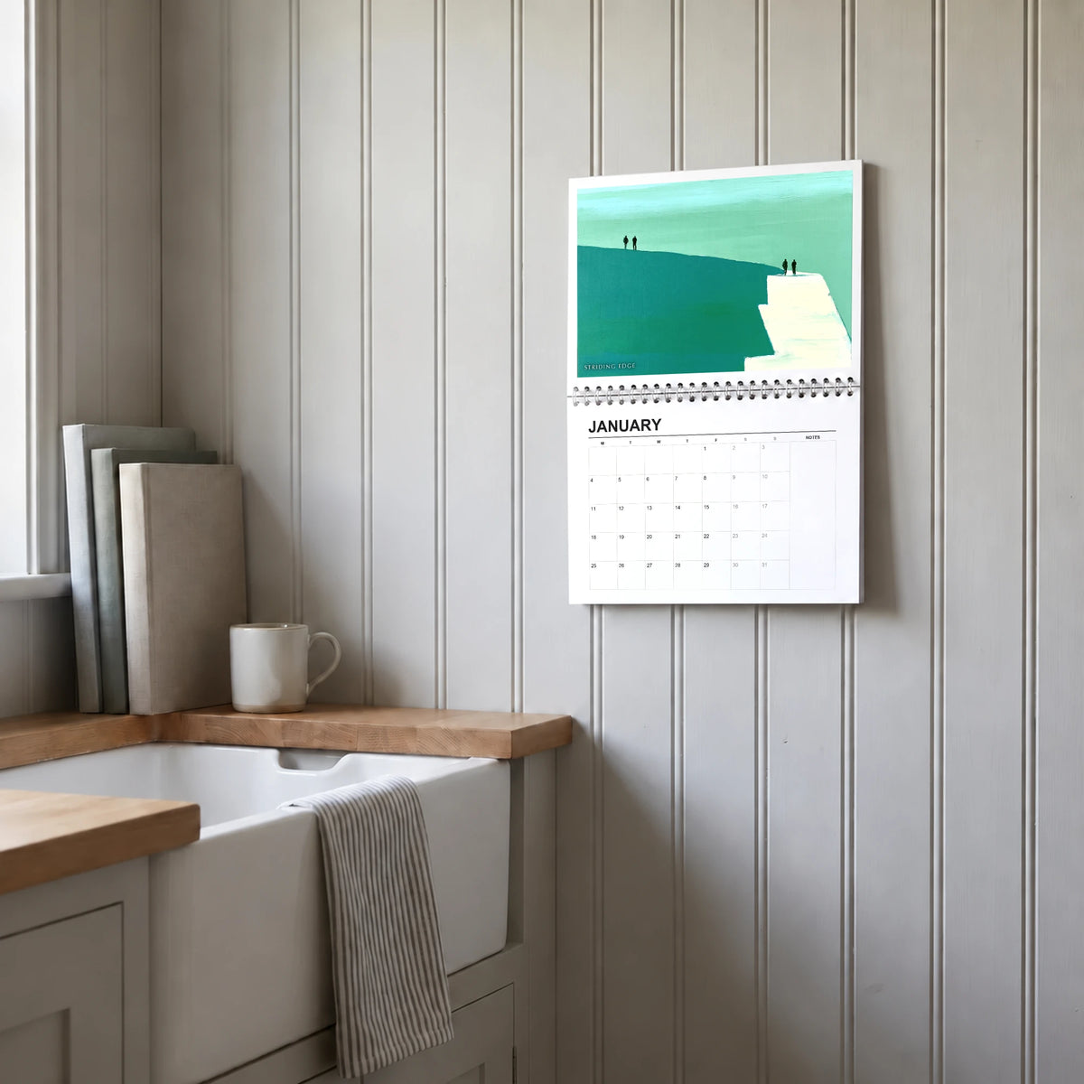 Sebastian Finch 2027 wall calendar hanging in a utility room