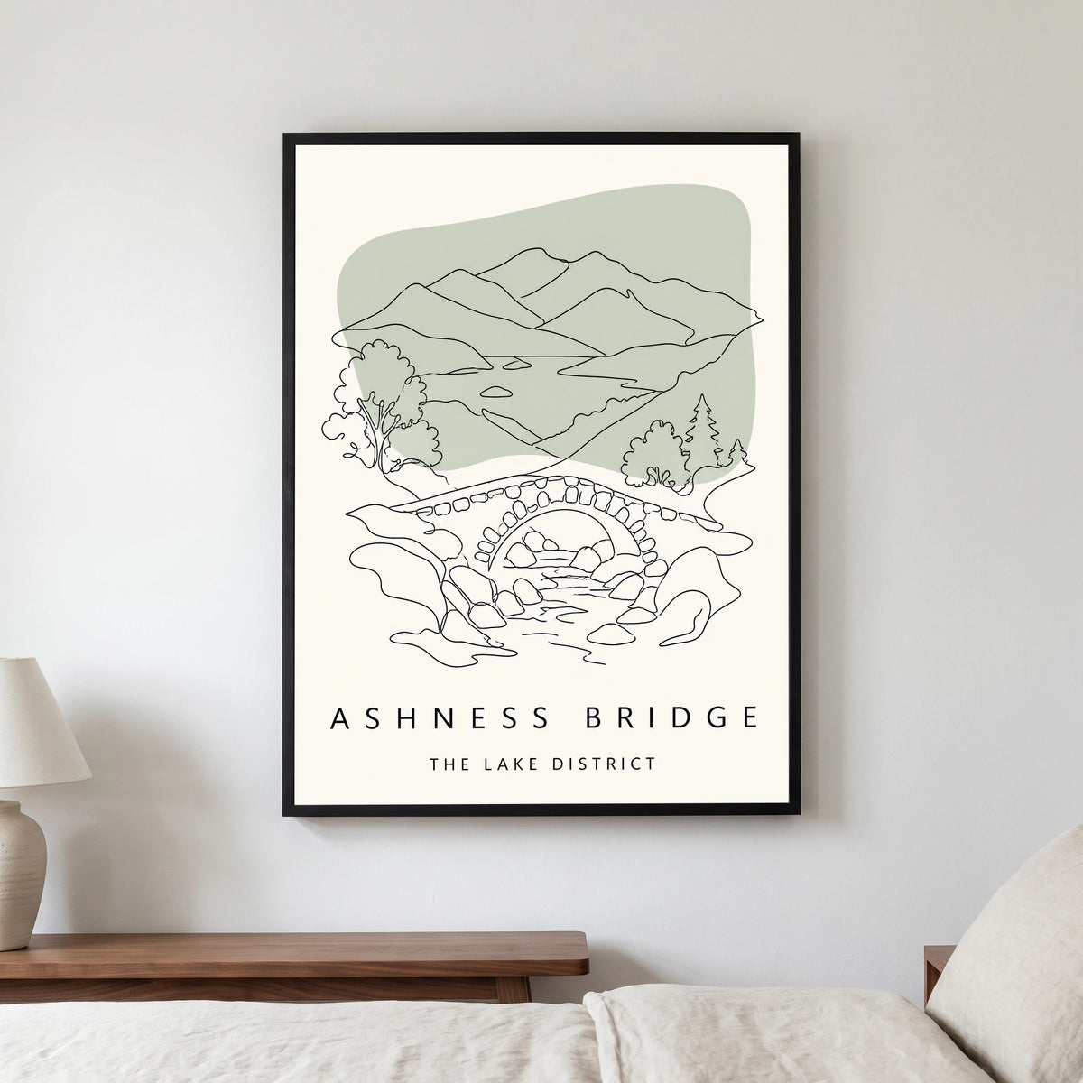 Ashness Bridge travel poster in a black frame, hanging in a bedroom3