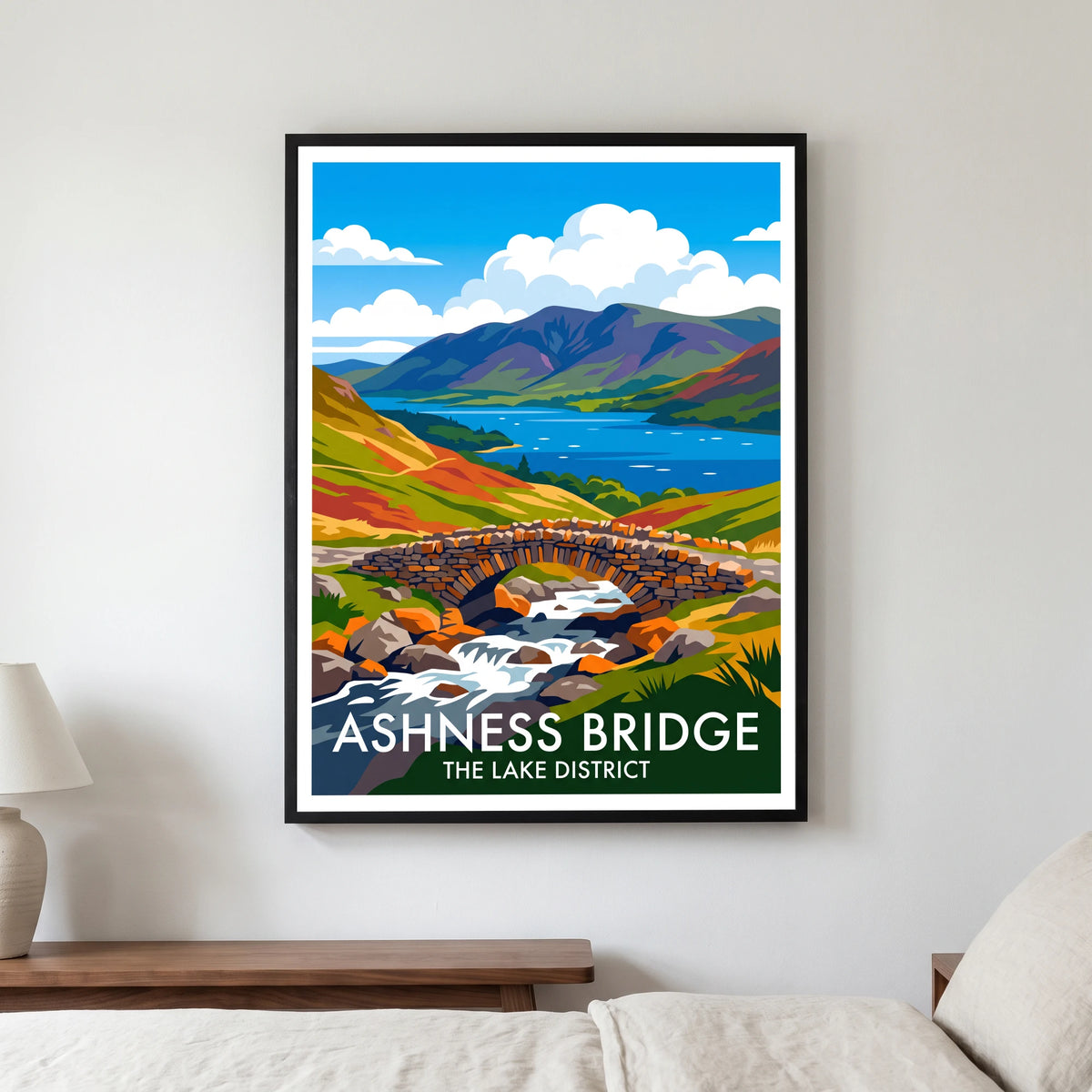 Ashness Bridge travel poster in a black frame, hanging in a bedroom3