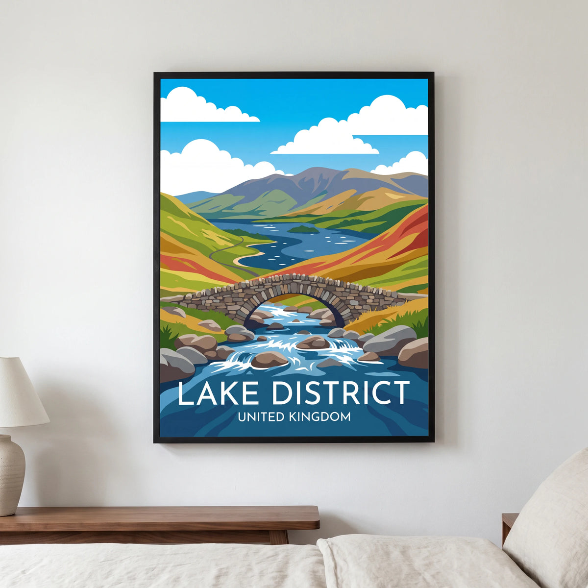 Ashness Bridge travel poster in a black frame, hanging in a bedroom3