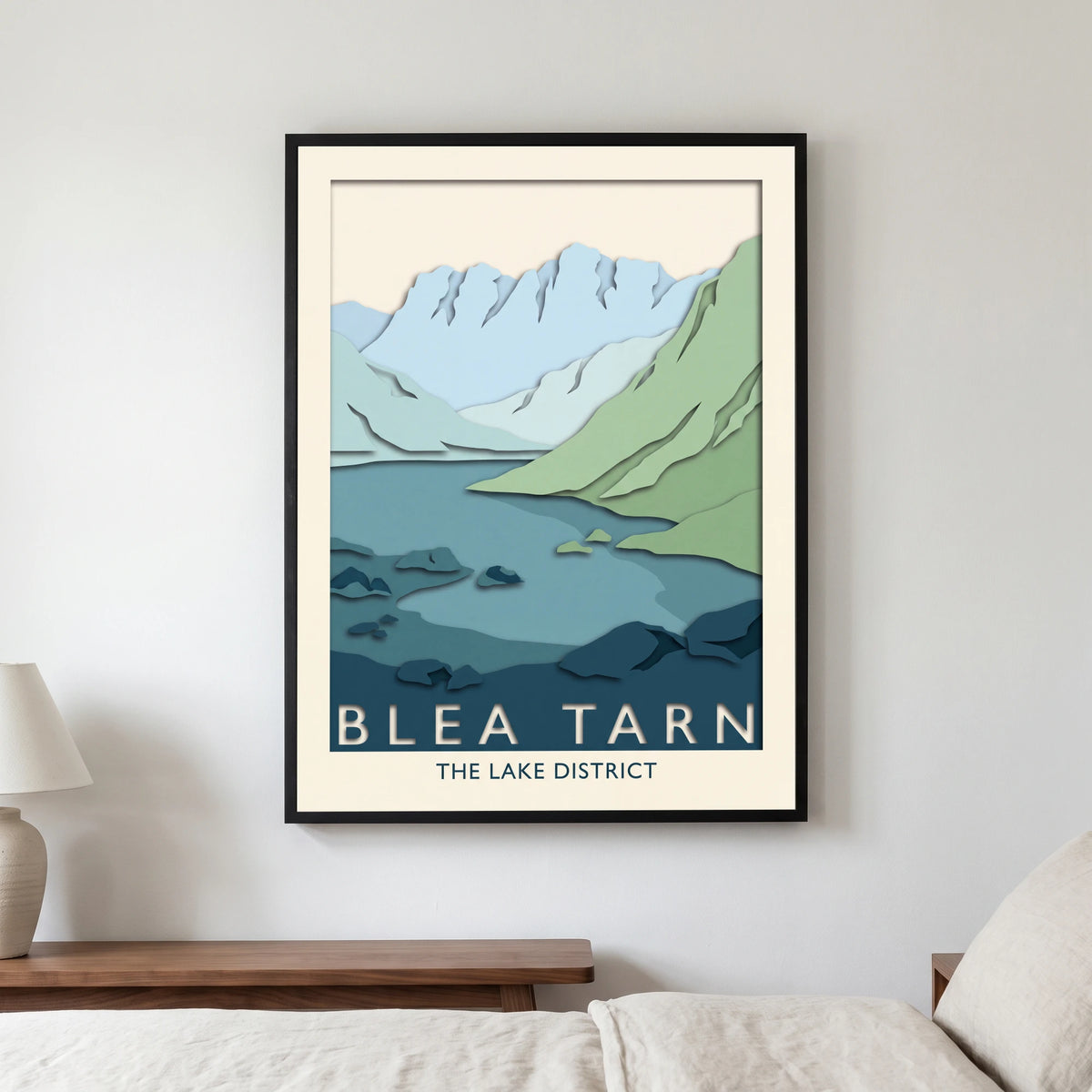 Blea Tarn travel poster in a black frame, hanging in a bedroom3