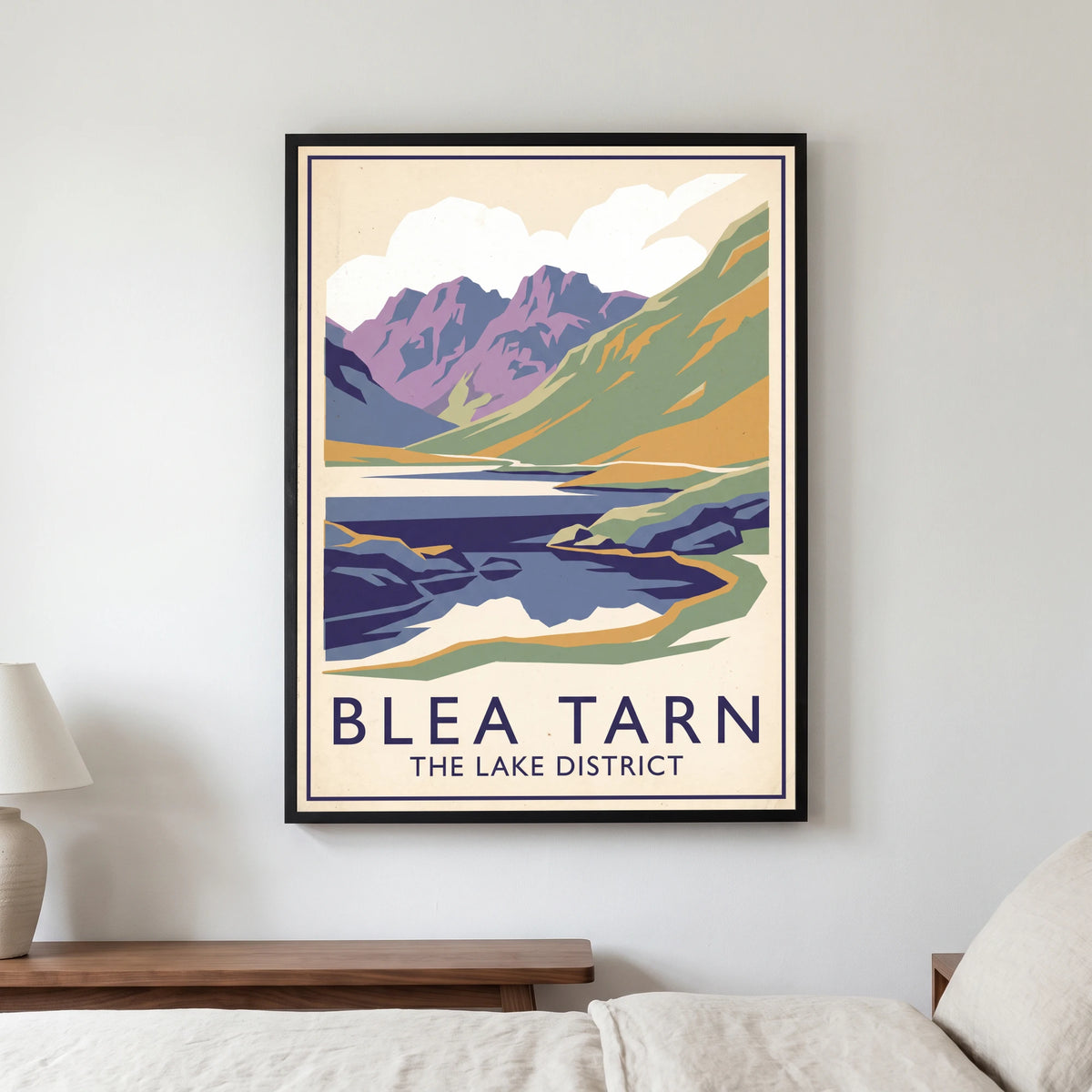 Blea Tarn travel poster in a black frame, hanging in a bedroom3