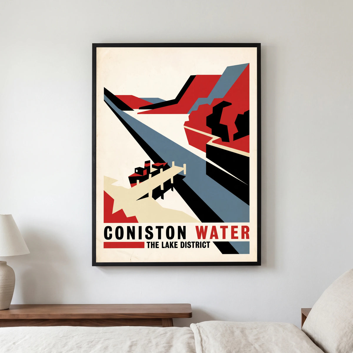 Coniston Water travel poster in a black frame, hanging in a bedroom3