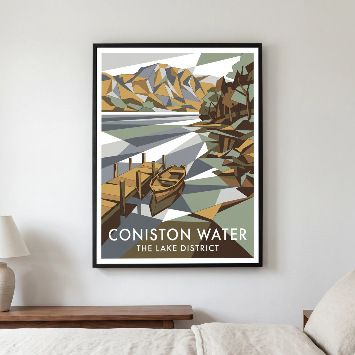 Coniston Water travel poster in a black frame, hanging in a bedroom3