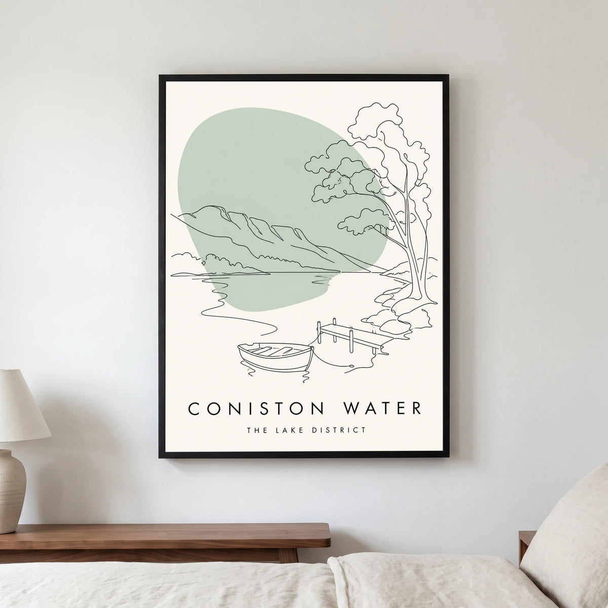 Coniston Water travel poster in a black frame, hanging in a bedroom3