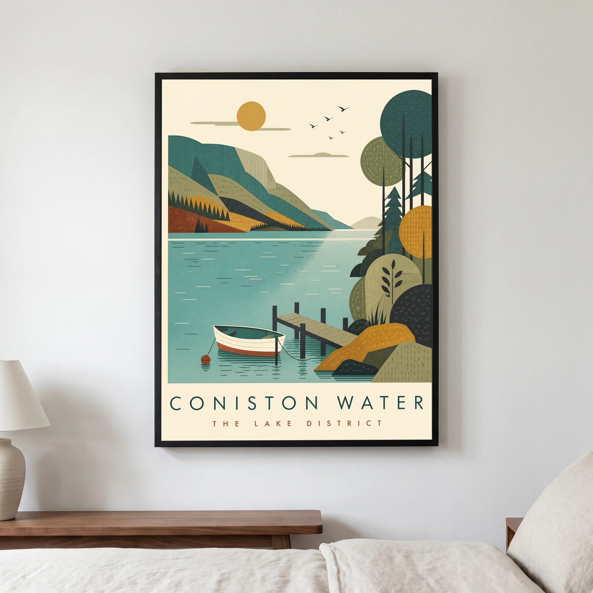 Coniston Water travel poster in a black frame, hanging in a bedroom3