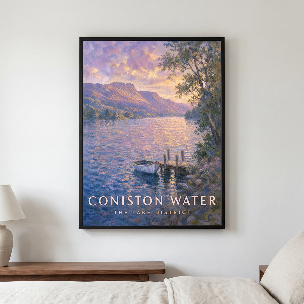 Coniston Water travel poster in a black frame, hanging in a bedroom3