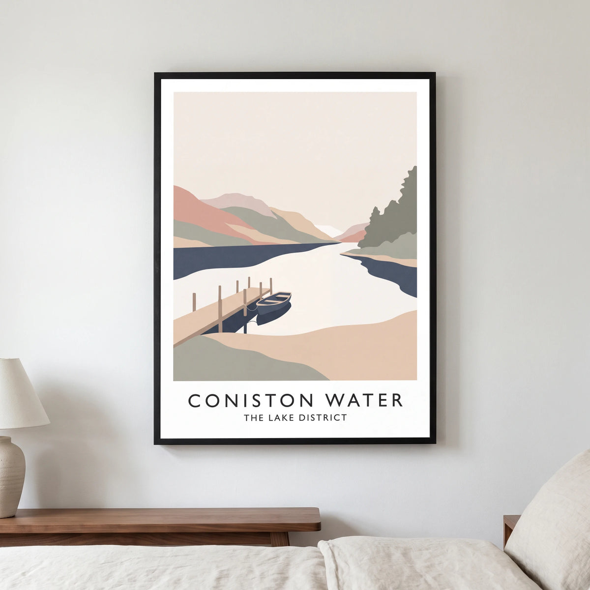Coniston Water travel poster in a black frame, hanging in a bedroom3