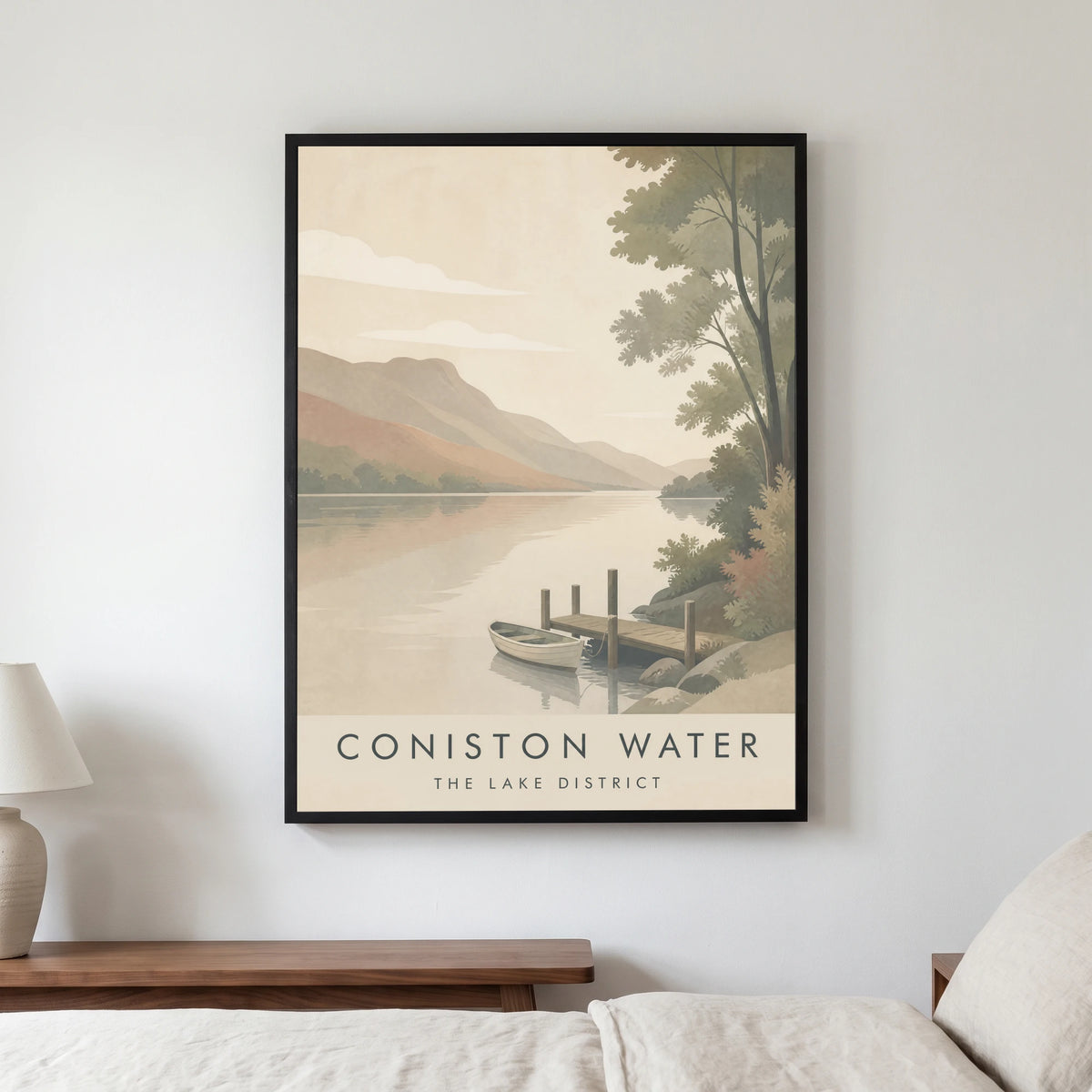 Coniston Water travel poster in a black frame, hanging in a bedroom3