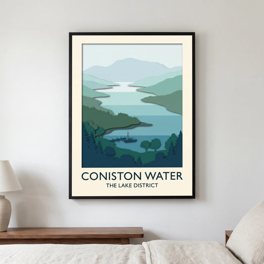 Coniston Water travel poster in a black frame, hanging in a bedroom3