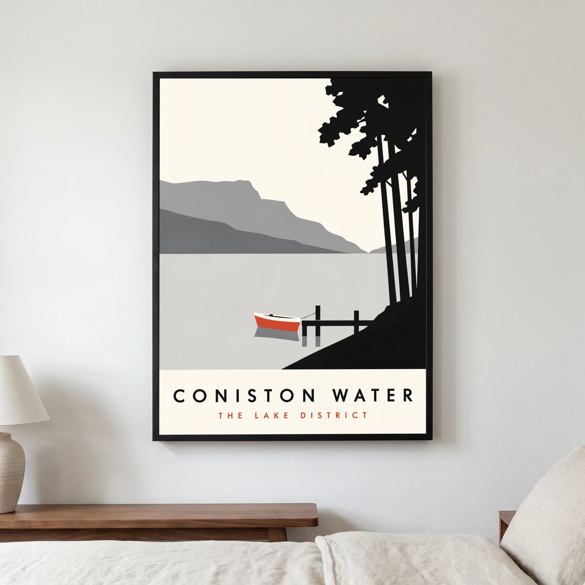 Coniston Water travel poster in a black frame, hanging in a bedroom3