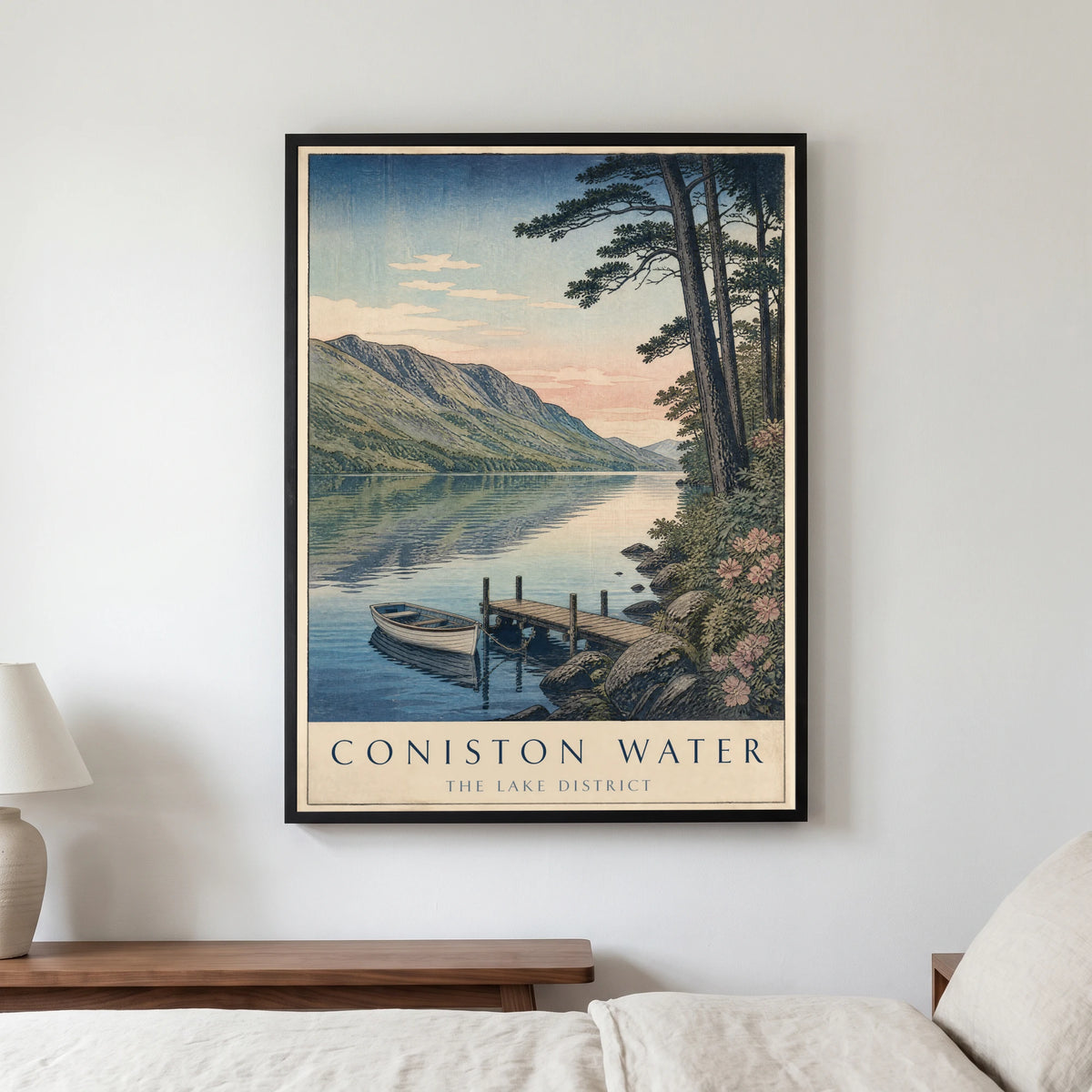 Coniston Water travel poster in a black frame, hanging in a bedroom3