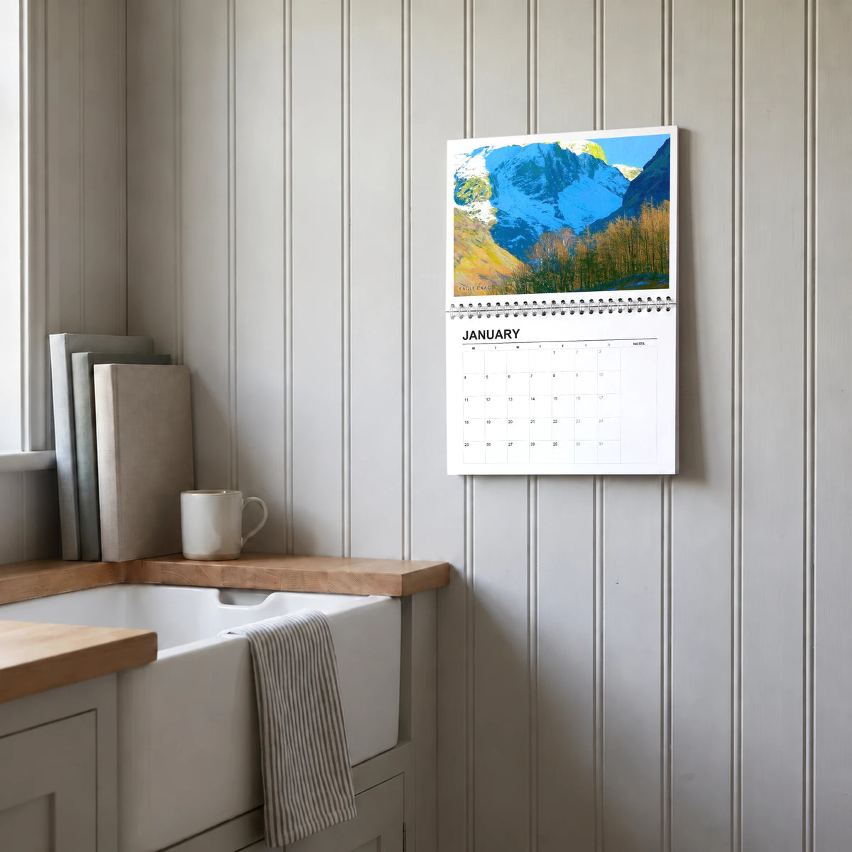 Daphne Morley 2027 wall calendar hanging in a utility room