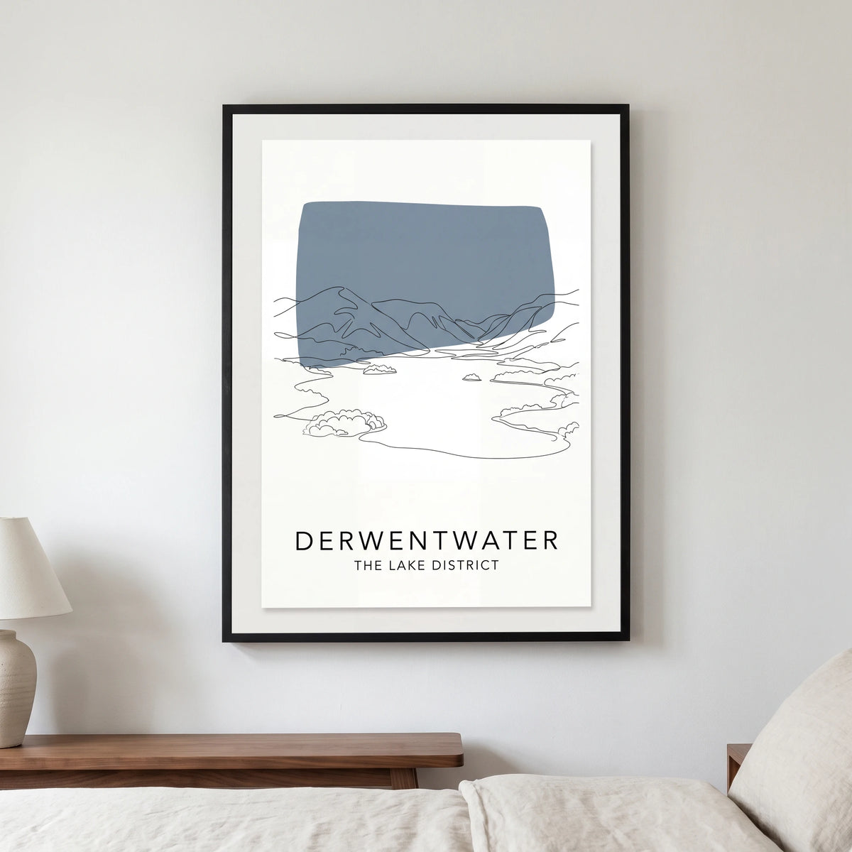 Derwentwater travel poster in a black frame, hanging in a bedroom3