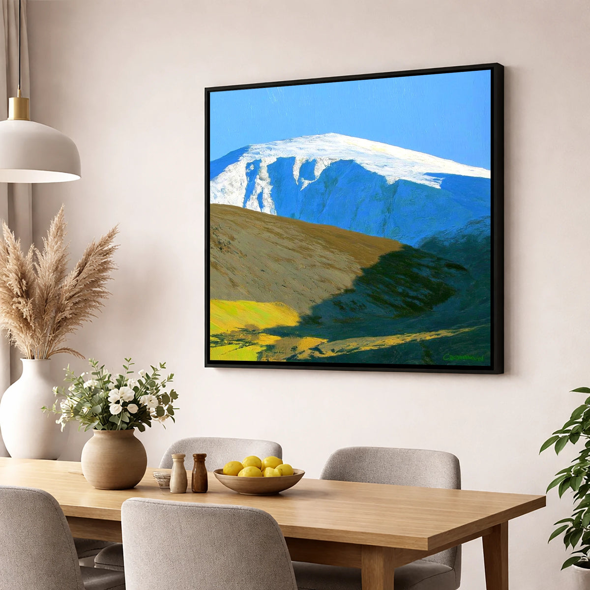 Sunlight on Snow Capped Raise lake district fell wall art displayed in a dining room