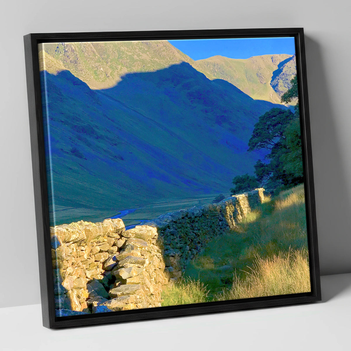 Sunlit Wall and Shadowed Fells lake district valley canvas wall art in black frame