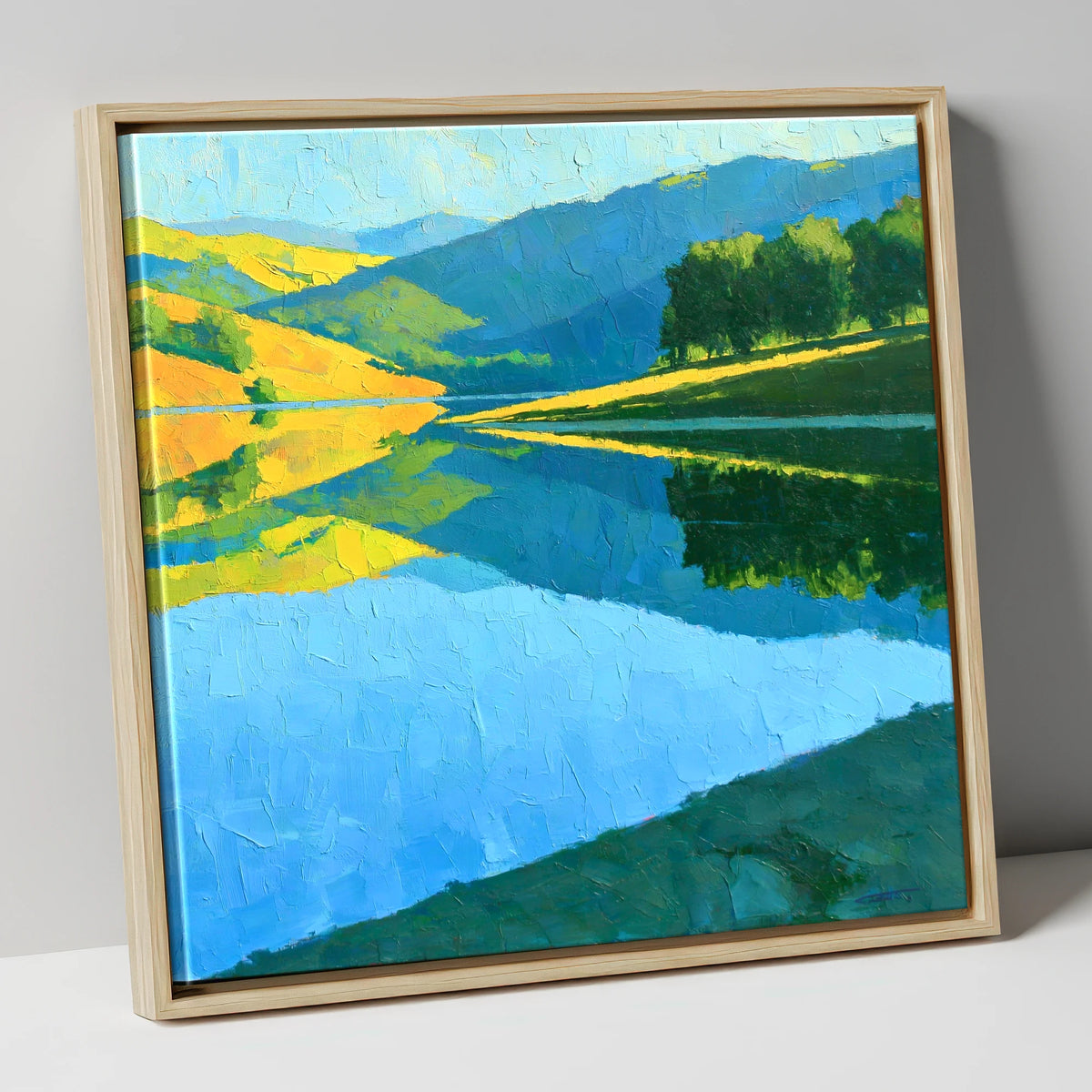 Sunlit Fells Mirrored in Blue Water lake district lake canvas wall art in natural frame