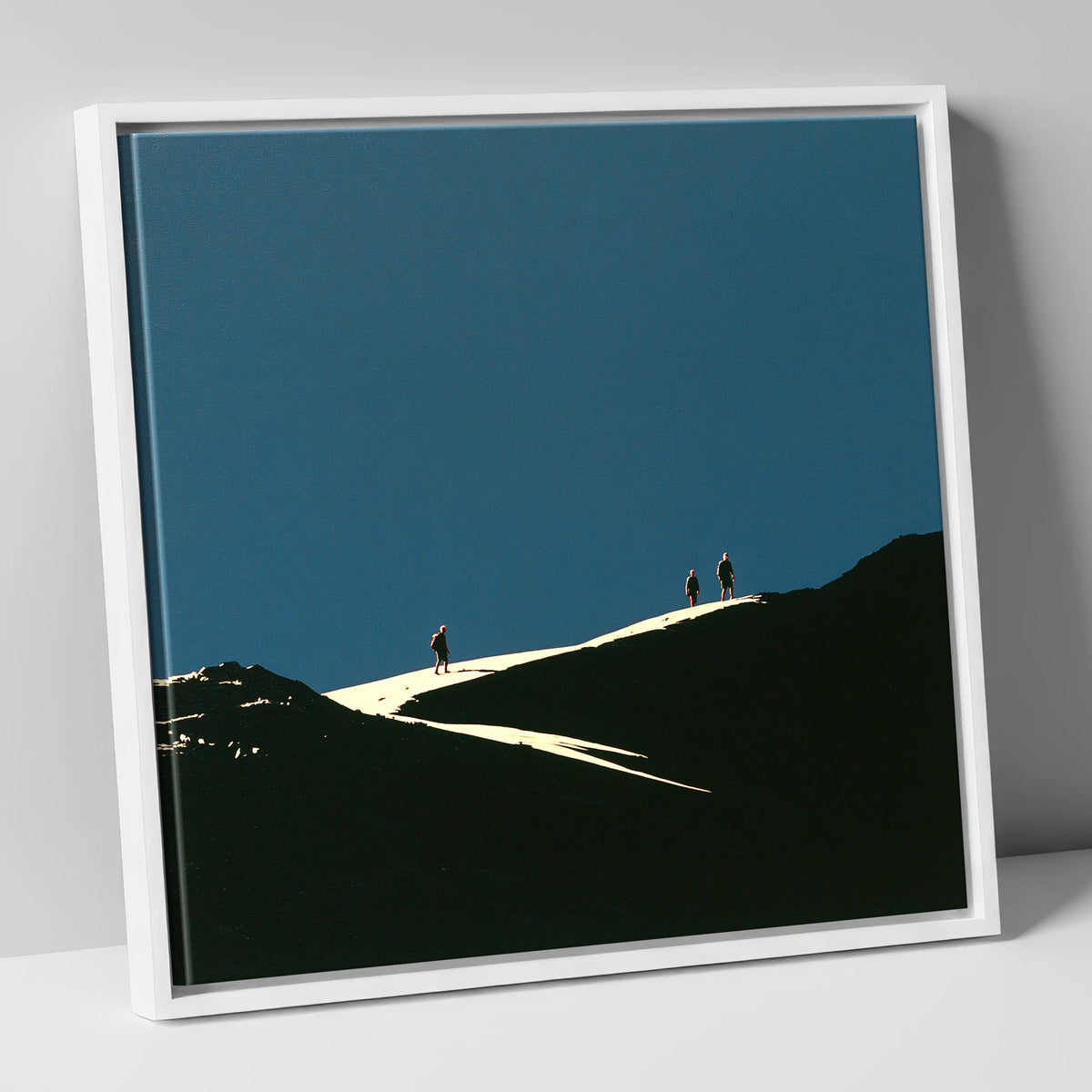 Hikers on a Sunlit Ridge lake district fell canvas wall art in white frame