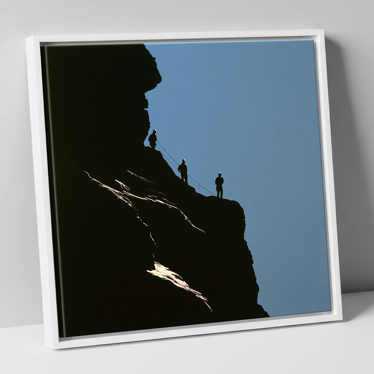 Silhouetted Climbers on a Crag lake district walking canvas wall art in white frame