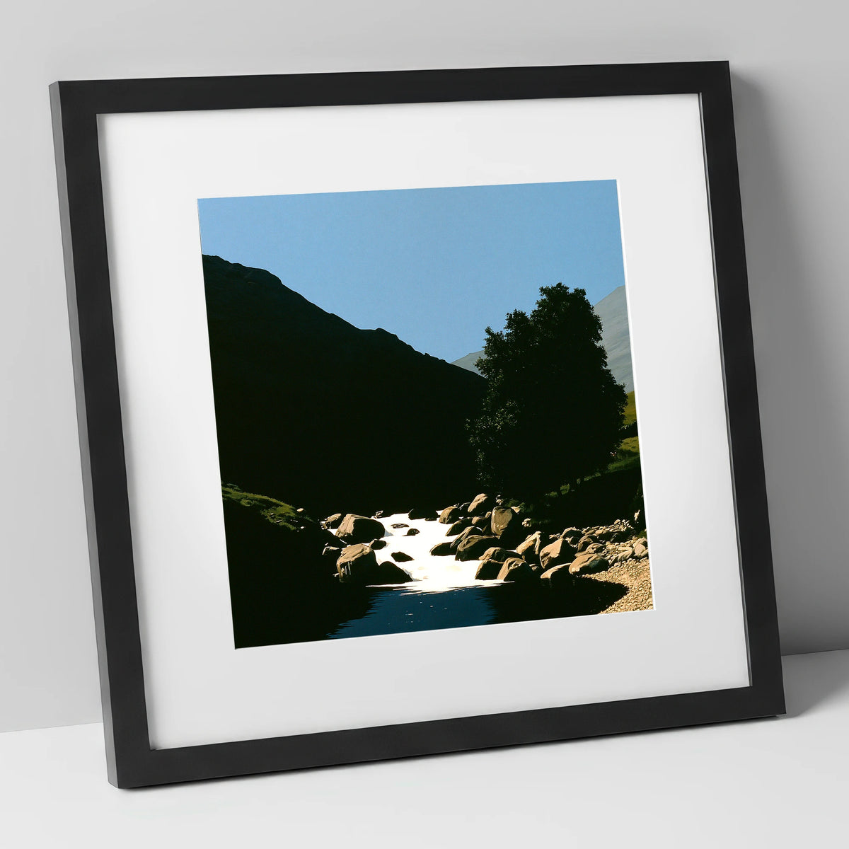Sunlit Beck Beneath Dark Fell lake district waterfall art print in black frame