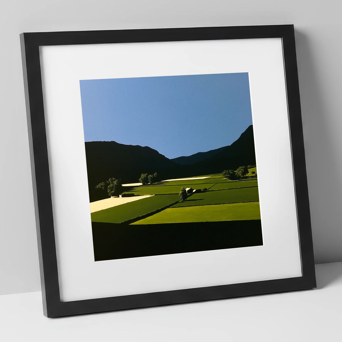 Sunlit Patchwork Fields in a Dale lake district valley art print in black frame
