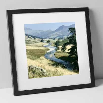 Winding River Beneath Hazy Fells lake district waterfall art print in black frame