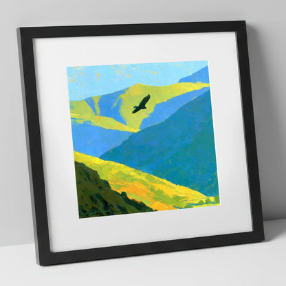 Soaring Bird of Prey Over Sunlit Fells lake district wildlife art print in black frame