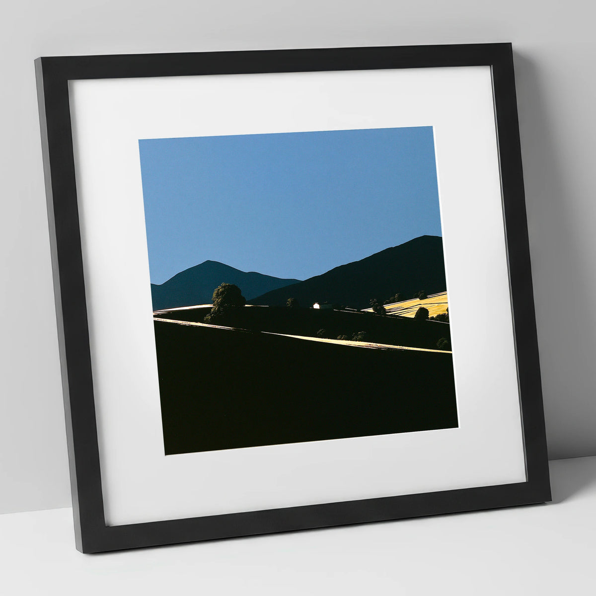 Golden Light on Silhouetted Fells lake district sky art print in black frame