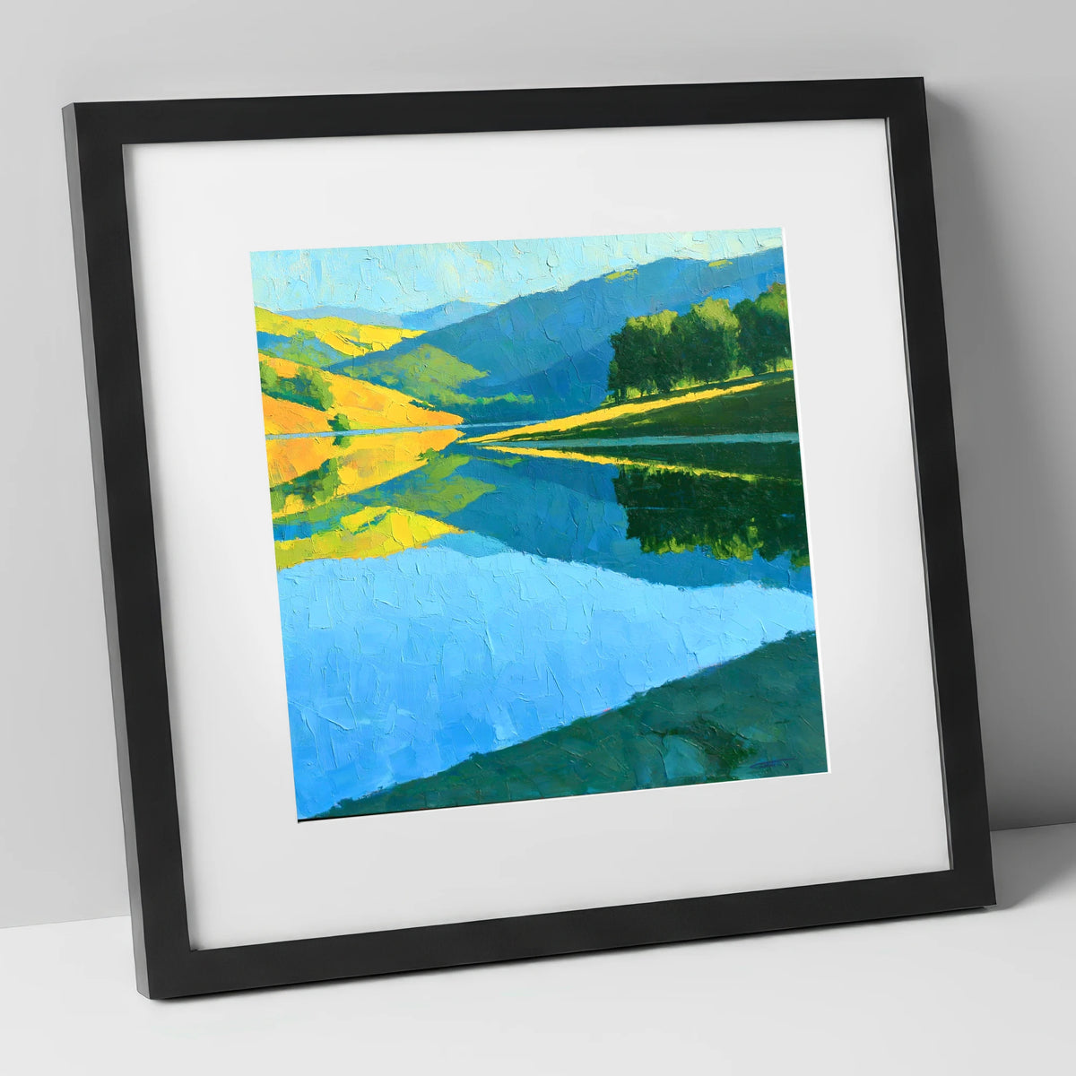 Sunlit Fells Mirrored in Blue Water lake district lake art print in black frame