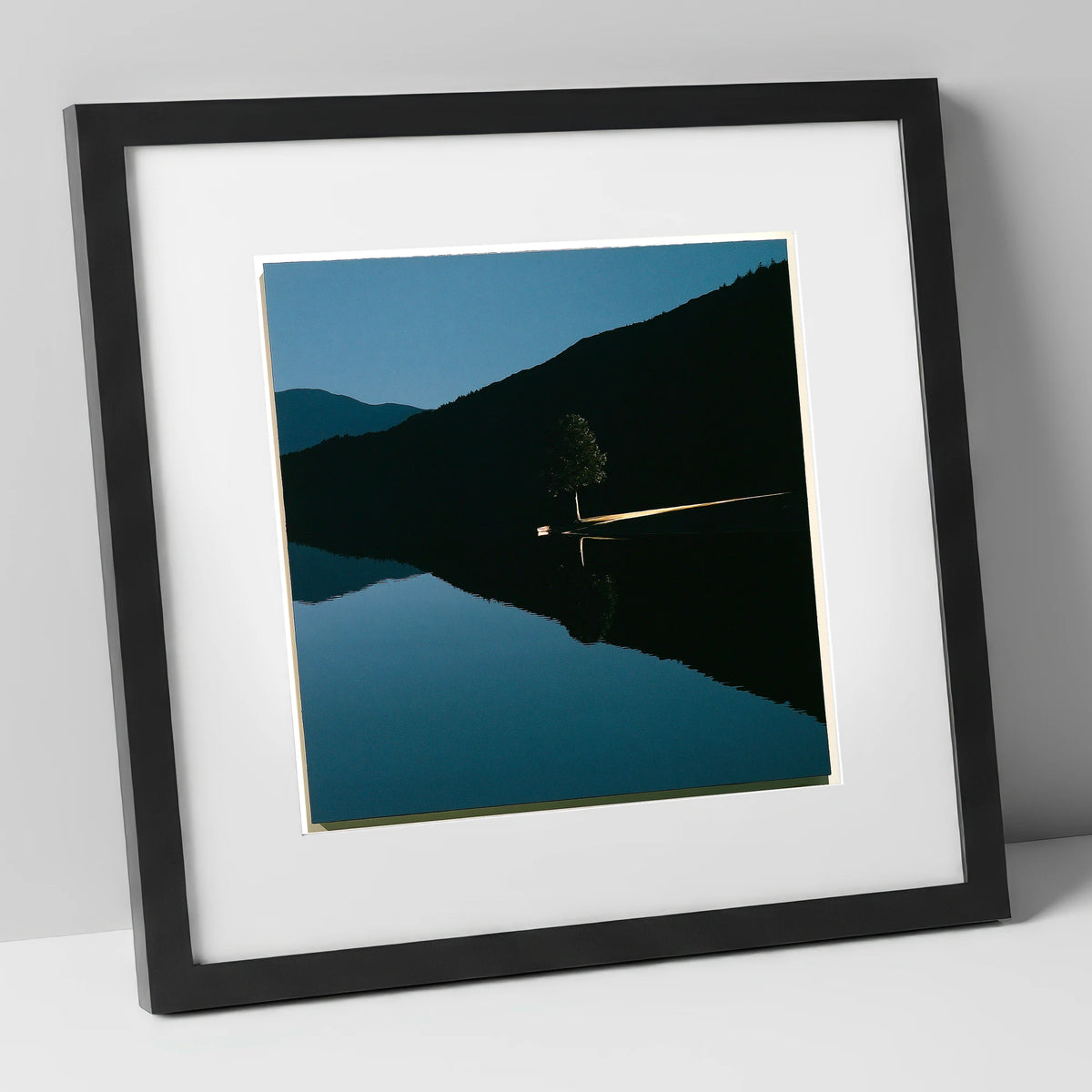 Illuminated Shore on Calm Lake lake district lake art print in black frame
