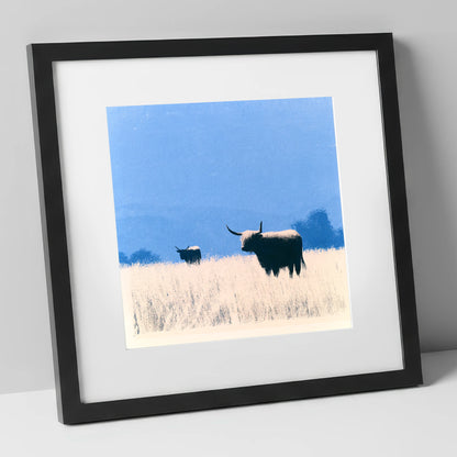 Highland Cattle Beneath Blue Skies lake district wildlife art print in black frame