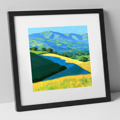Sunlight and Cloud Shadows over Fells lake district sky art print in black frame