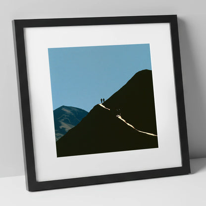 Walkers on a Sunlit Mountain Path lake district walking art print in black frame
