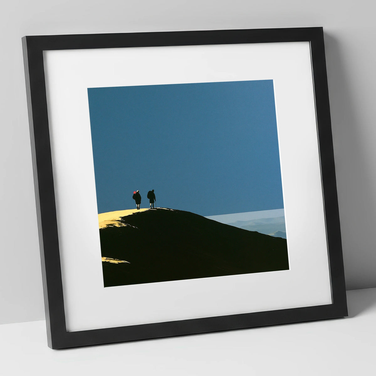 Silhouetted Hikers on a Fell Top lake district fell art print in black frame