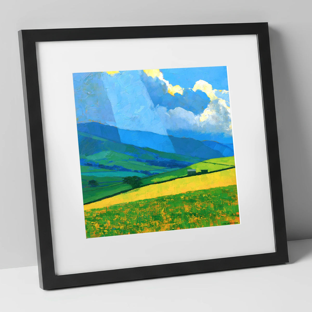 Sunlit Yellow Fields and Stormy Fells lake district sky art print in black frame