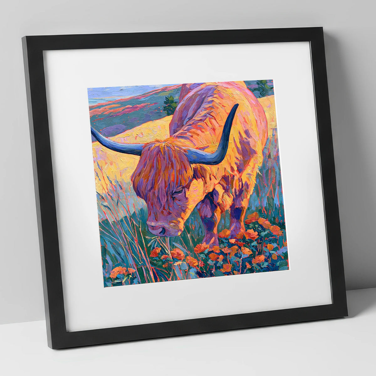 Vibrant Highland Cow Grazing the Fells lake district wildlife art print in black frame