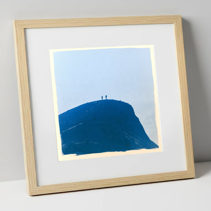 Hikers on a Blue Fell Top lake district fell art print in natural frame