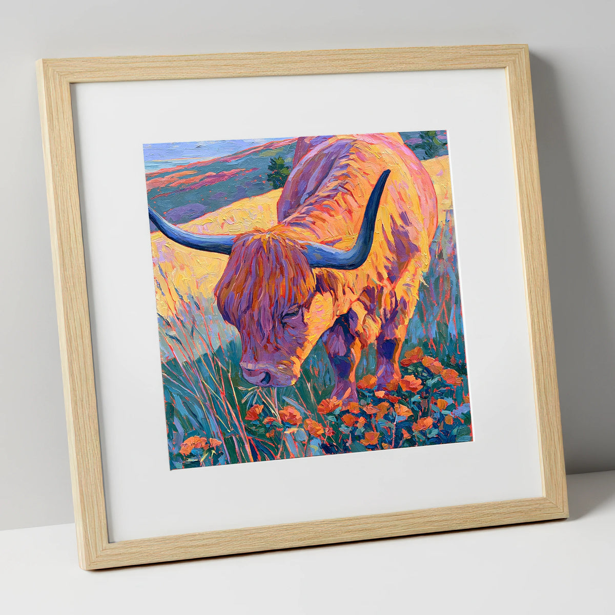 Vibrant Highland Cow Grazing the Fells lake district wildlife art print in natural frame