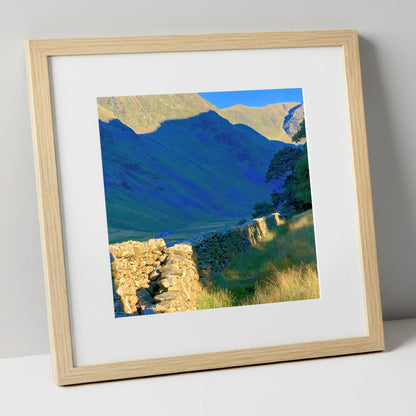 Sunlit Wall and Shadowed Fells lake district valley art print in natural frame