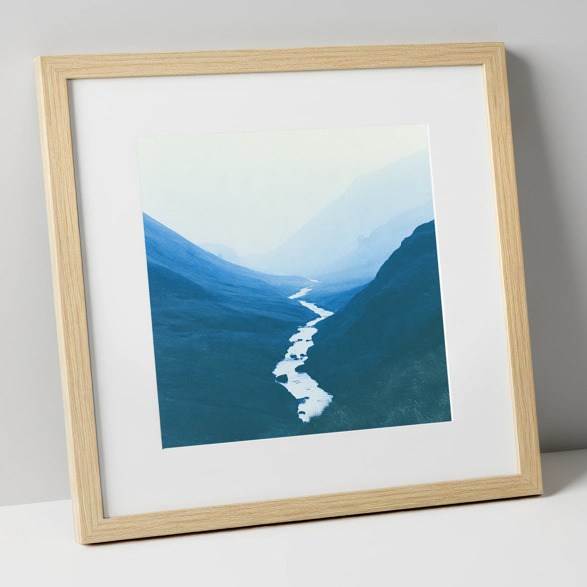River Winding Through Blue Fells lake district waterfall art print in natural frame