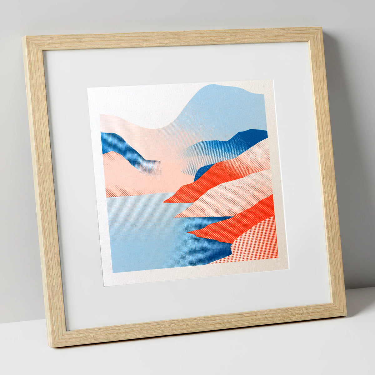 Graphic Buttermere in Coral and Blue lake district lake art print in natural frame