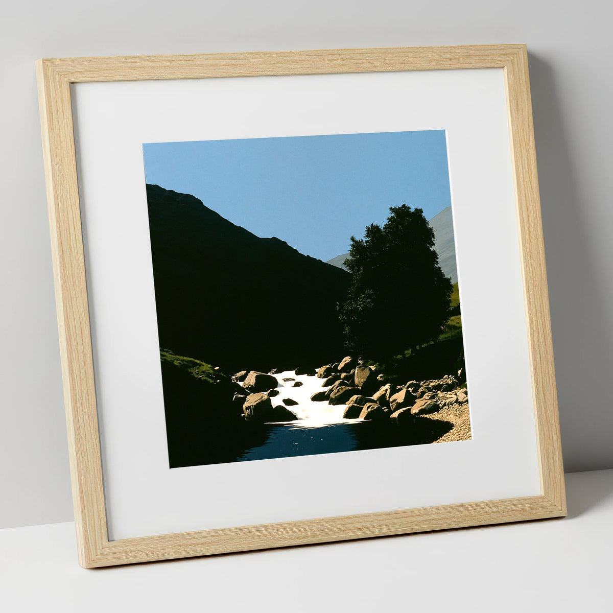 Sunlit Beck Beneath Dark Fell lake district waterfall art print in natural frame