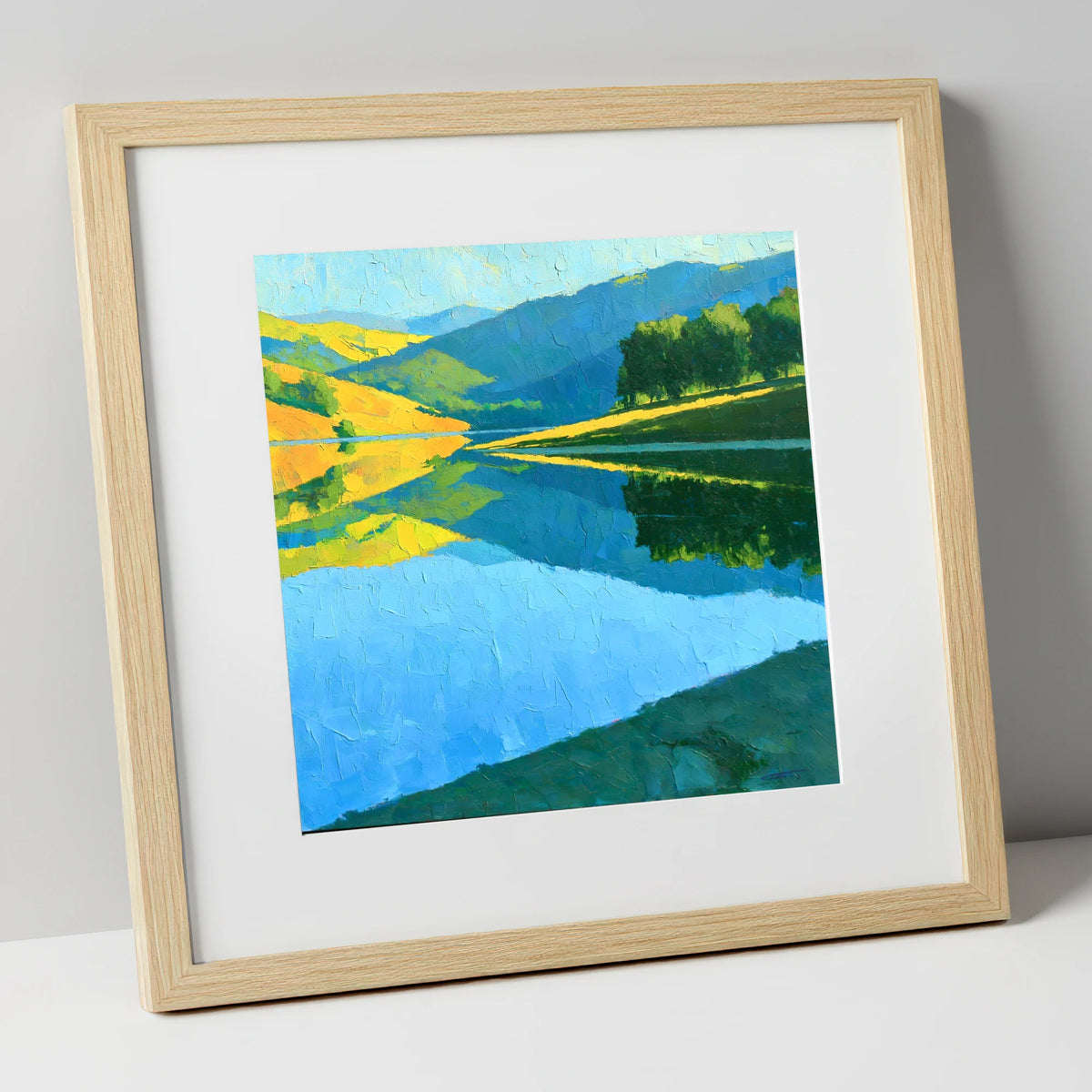 Sunlit Fells Mirrored in Blue Water lake district lake art print in natural frame