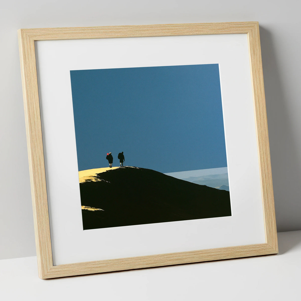 Silhouetted Hikers on a Fell Top lake district fell art print in natural frame