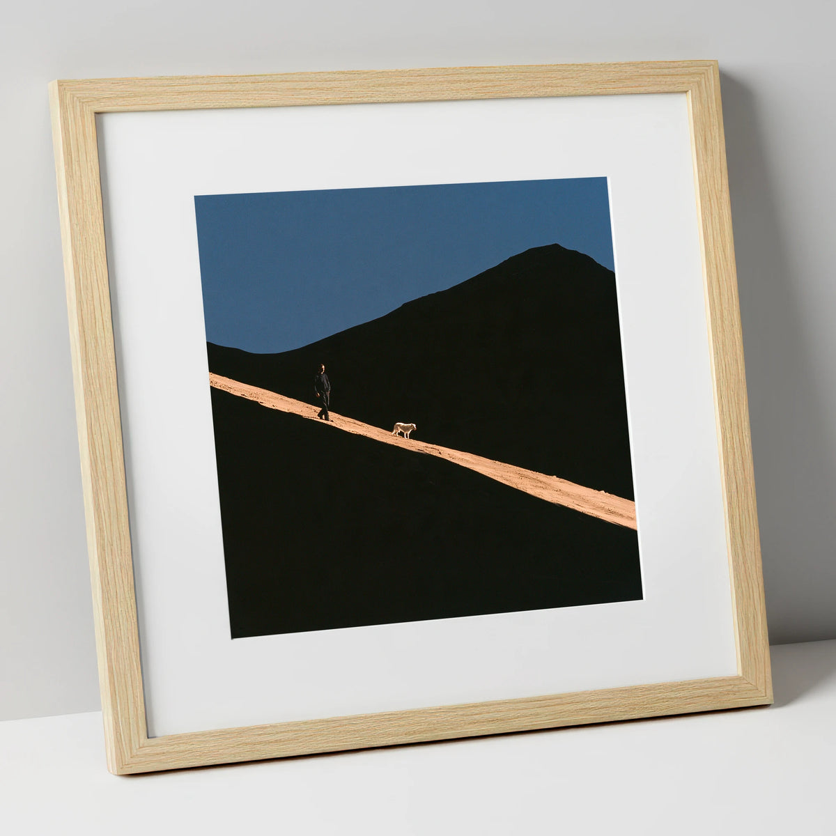 Dog Walker on Sunlit Skiddaw gifts for dog walkers art print in natural frame