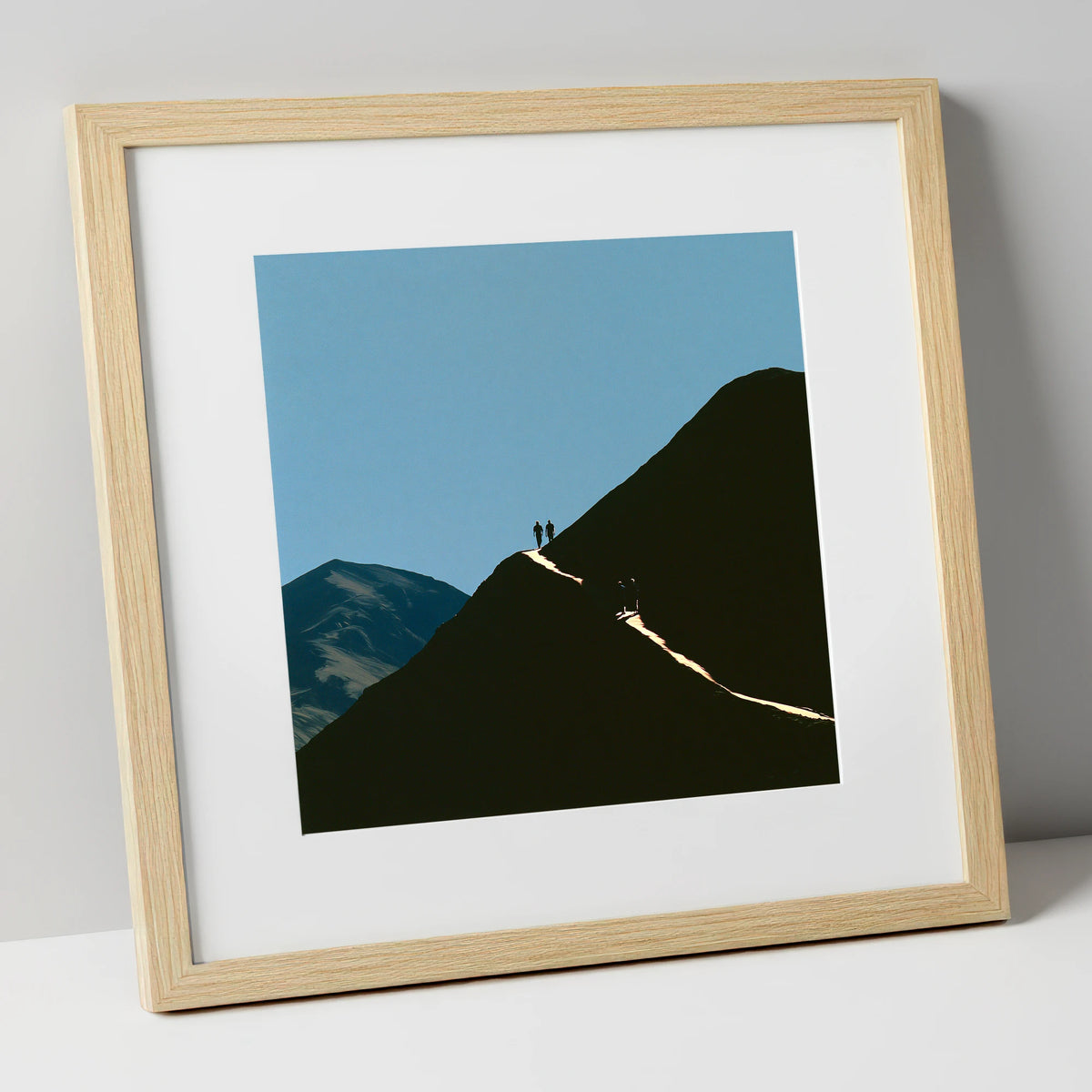 Walkers on a Sunlit Mountain Path lake district walking art print in natural frame