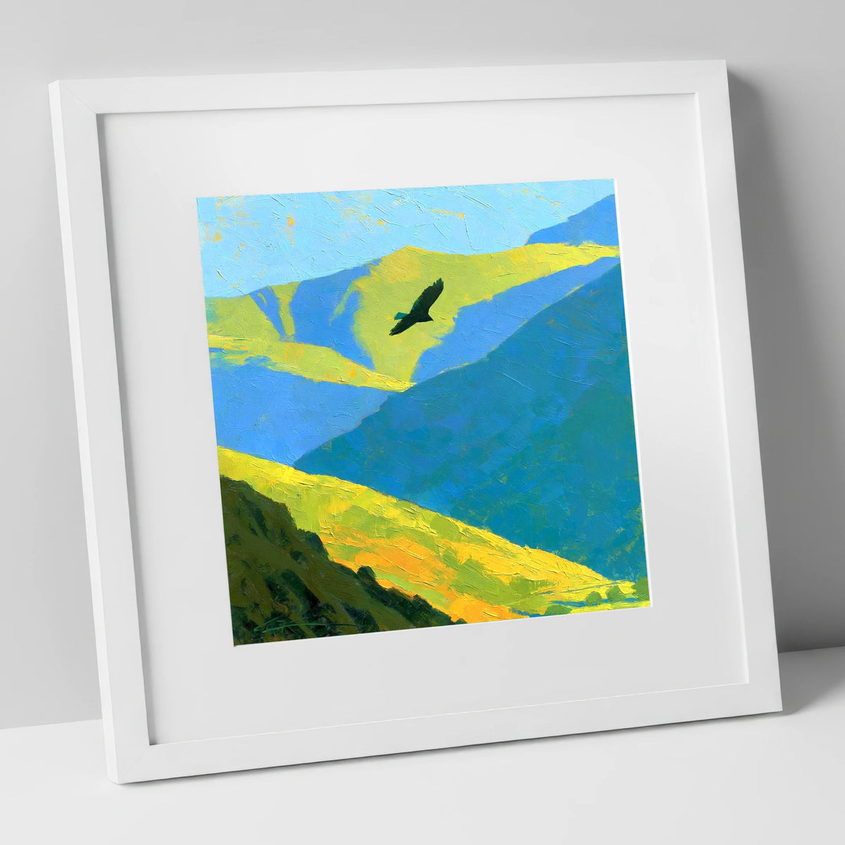 Soaring Bird of Prey Over Sunlit Fells lake district wildlife art print in white frame