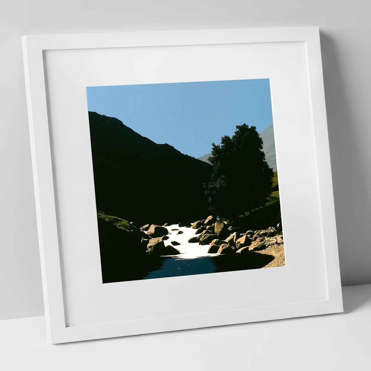 Sunlit Beck Beneath Dark Fell lake district waterfall art print in white frame