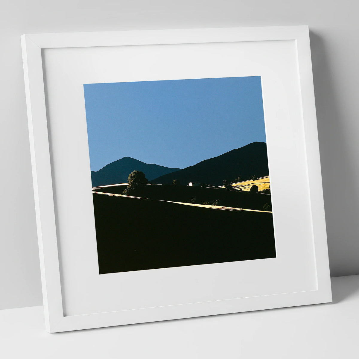 Golden Light on Silhouetted Fells lake district sky art print in white frame